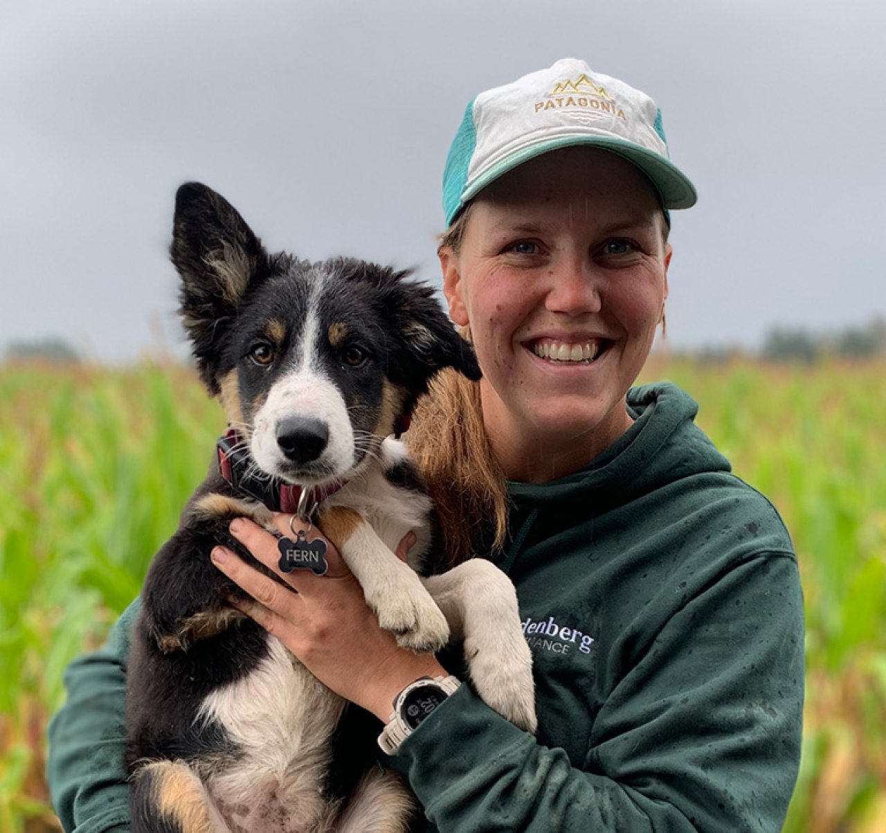 Gardener holding a puppy.